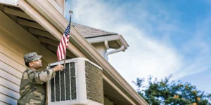 Professional HVAC technician servicing an air conditioning unit at a San Antonio home with military-grade safety standards