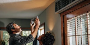 HVAC technician installing a smart thermostat in a San Antonio home